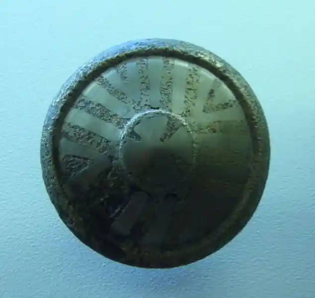 Stone inlaid with metal in the form of a cross